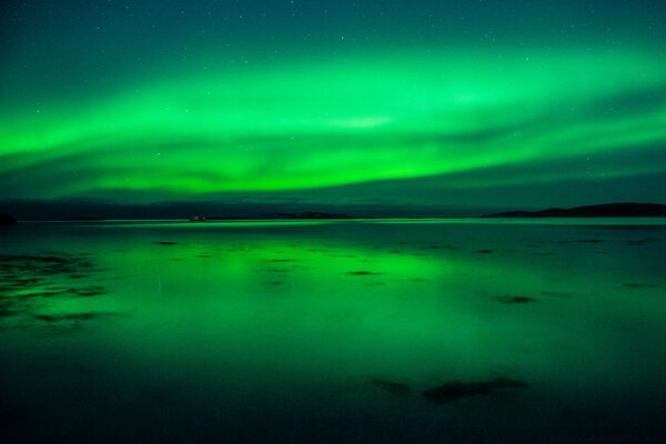 Blurred northern lights over the ocean