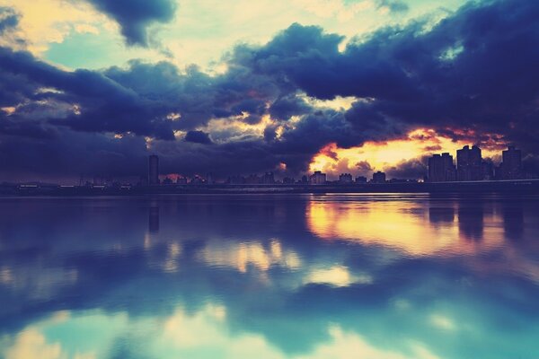 Sunset in the reflection of the city bay