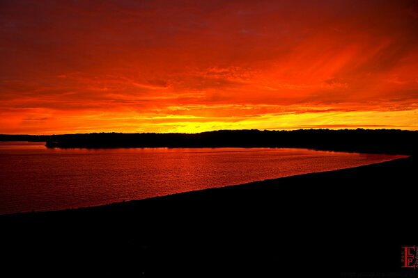 A bright sunset over the water surface