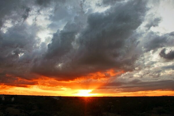 The red glow of sunset in a cloudy sky