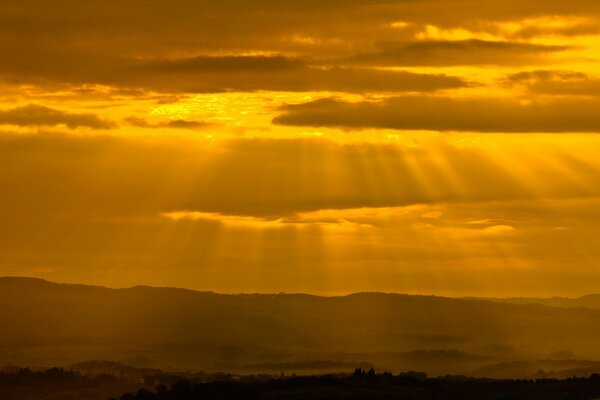 The sun s rays penetrate through thick clouds