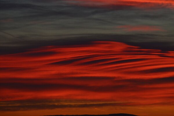 Puesta de sol rojo-gris en las nubes