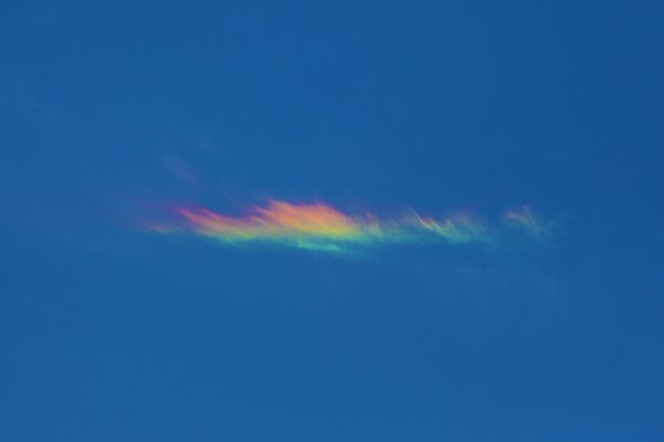 A lonely cloud shimmers with rainbow colors