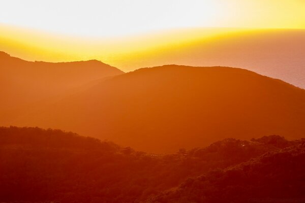 Silhouette of mountains in the sunny sky