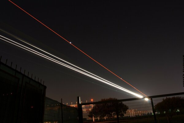 En el cielo nocturno se ven líneas rectas brillantes