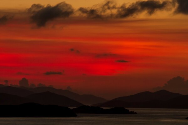 Bloody sunset on the background of mountains