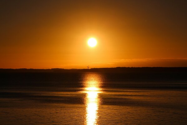 Bright red sunset by the water