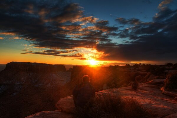 A man sitting admiring the sunset