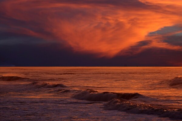 Evening sunset. Gloomy sky on the water