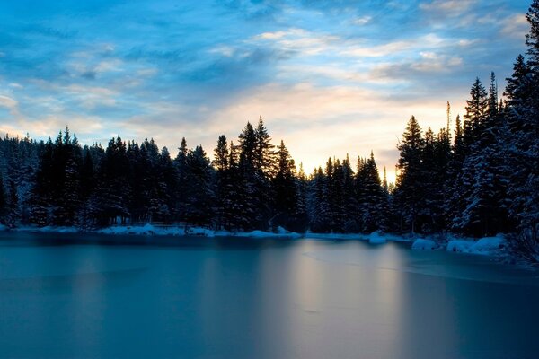 Sunset and frozen lake in winter