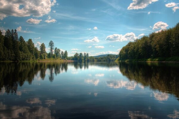 The sky is reflected in a crystal clear lake