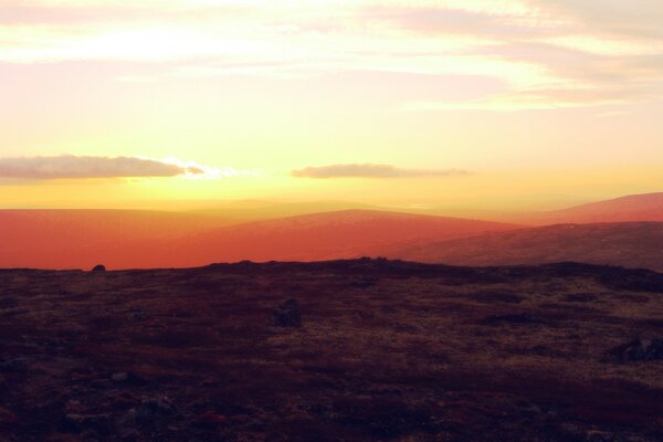 Dawn over the mountain peaks. Sky