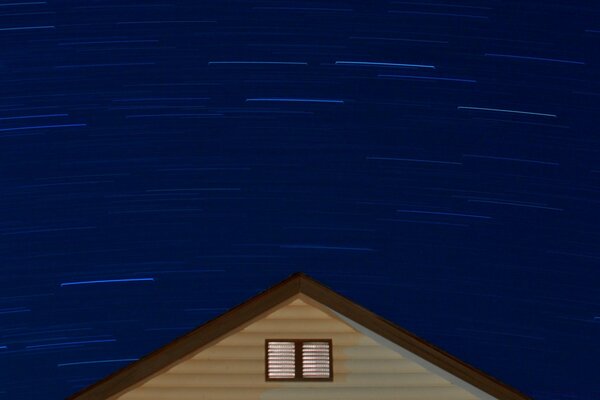 Slow motion shooting of the sky with stars above the roof