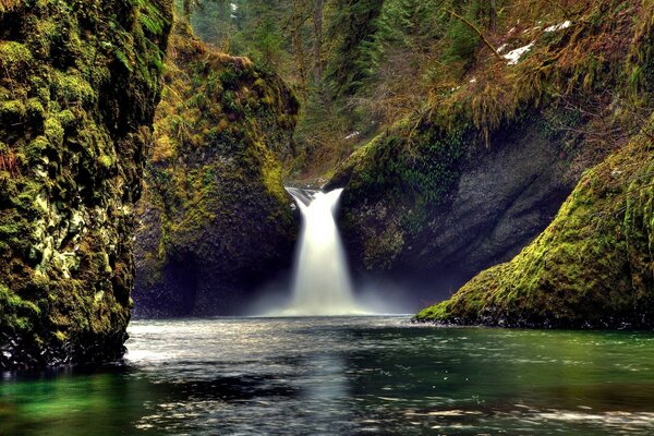 A beautiful waterfall falling into the river