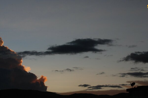 The sky is covered with yellow-blue clouds at dawn