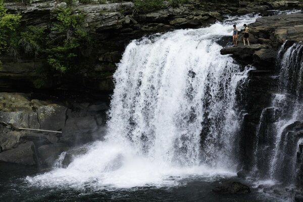 Image of a small waterfall with people