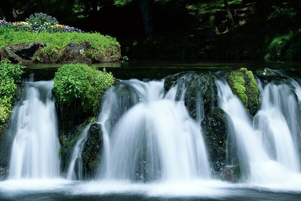 Cascade of waterfalls into a stormy river