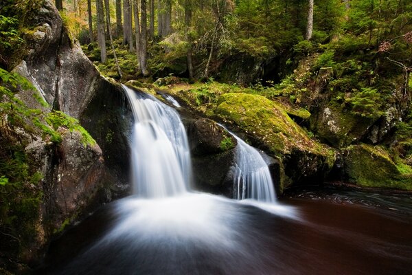 A stream of waterfalls descend down into the river