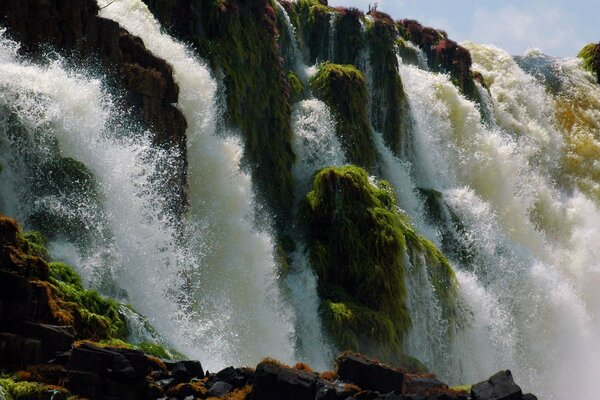 A stormy waterfall among high mountain slopes