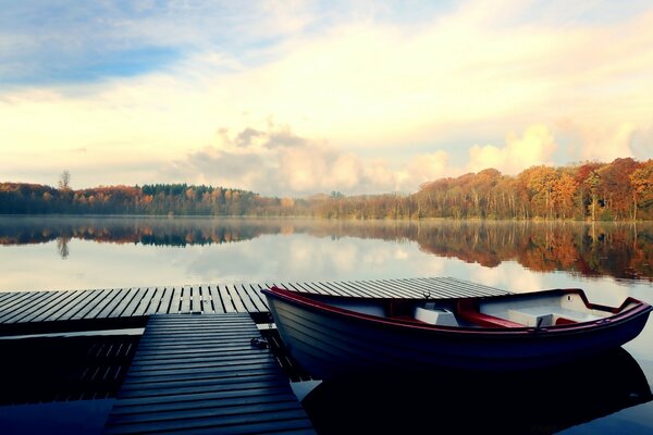 Boat, pier, lake and forest panorama