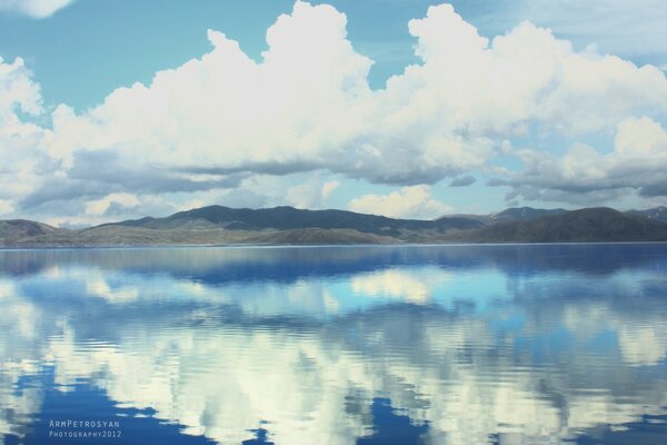 Reflection of cumulus clouds in the lake