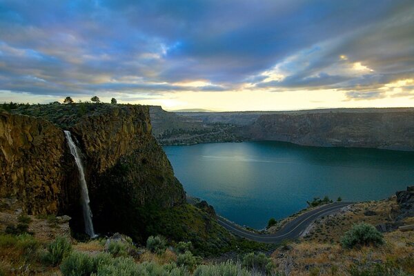 Winding road along the bay and waterfall