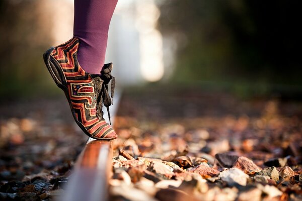 A woman reaches for the last rays of the autumn sun