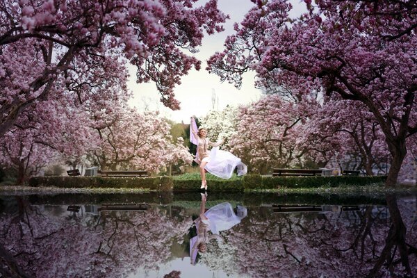 Photo shoot by the water, among flowering trees