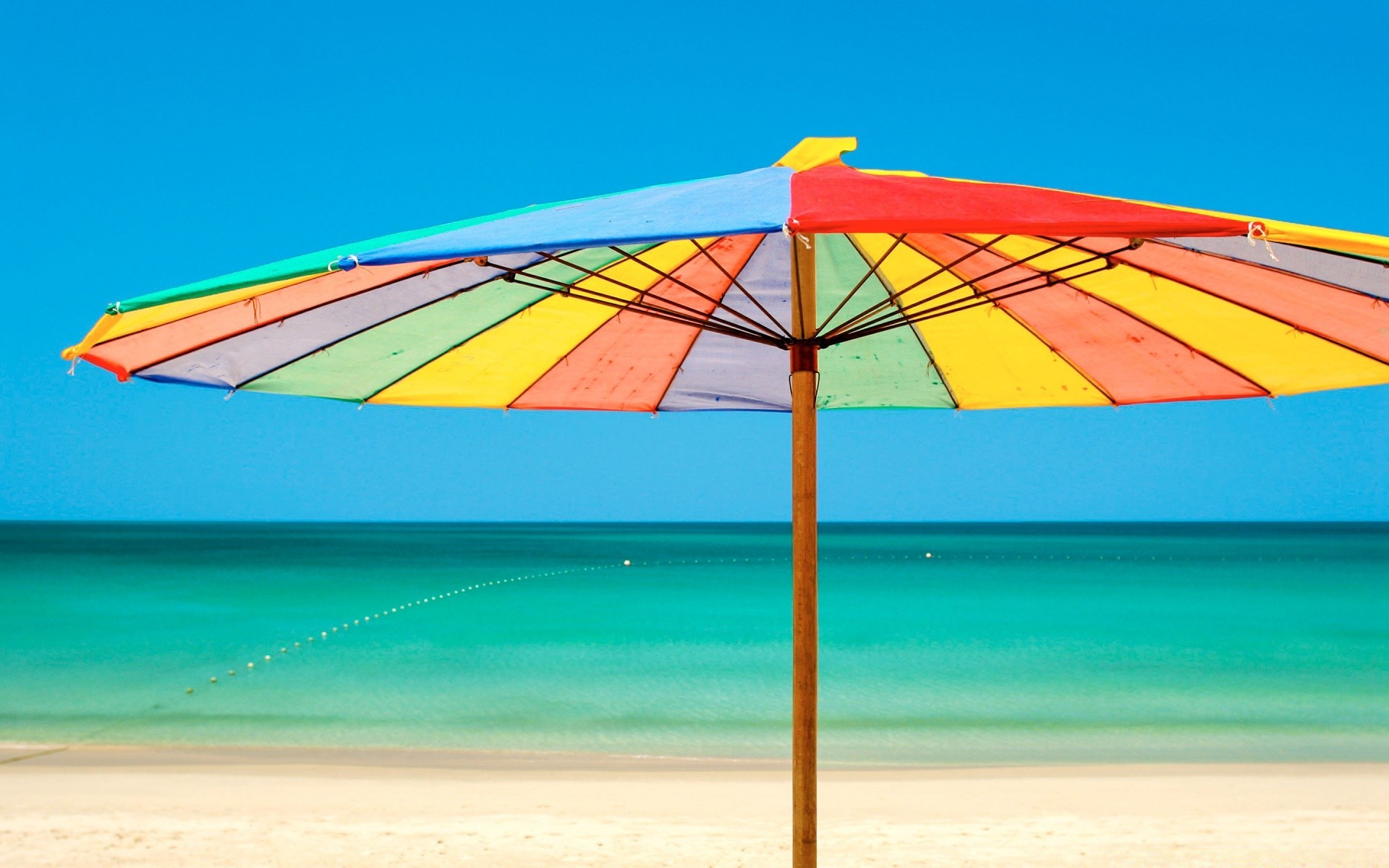 summer umbrella sand sky sunshade beach travel leisure sun tropical outdoors vacation water nature