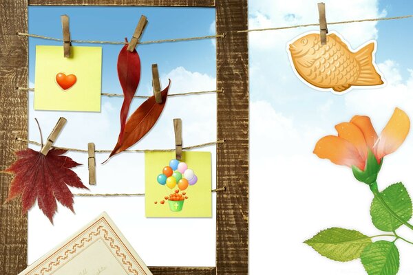 Autumn leaves and drawings attached to ropes with clothespins