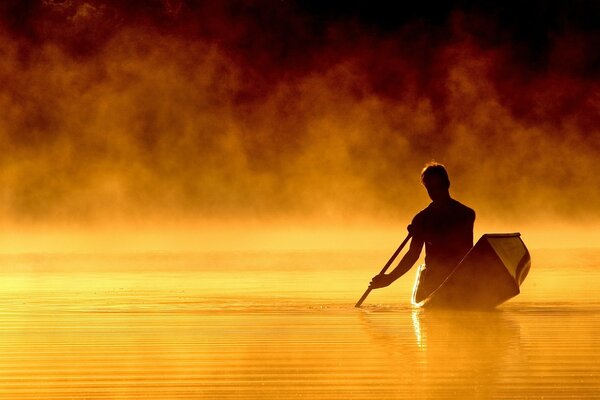 A man in a boat is floating on the water