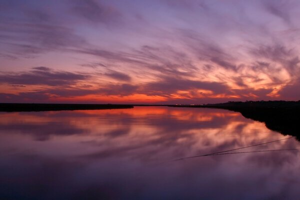 Reflejo de la puesta de sol en el lago. Puesta de sol roja