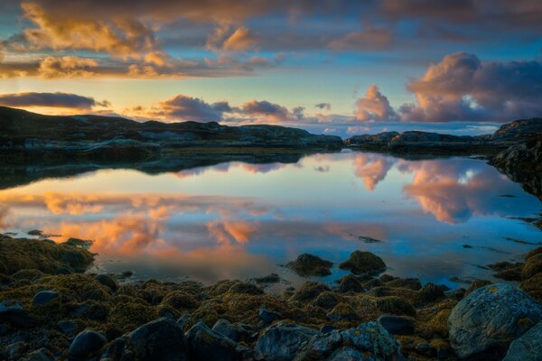 Las nubes se reflejan en el agua clara