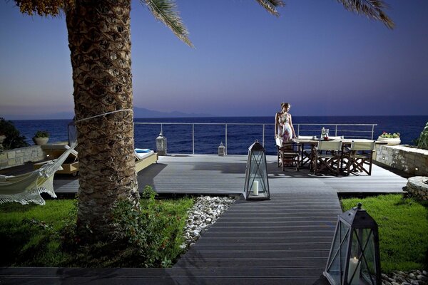 A girl in a restaurant on the pier by the sea