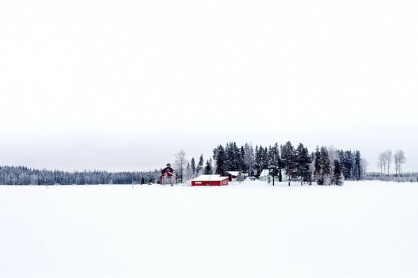 A red building in a snow-covered field