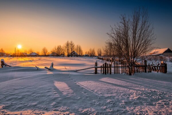 Dawn in the village in winter. Native land