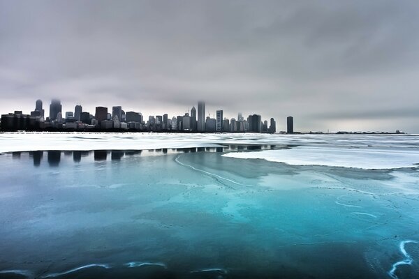 In winter, freezing water on the background of the city