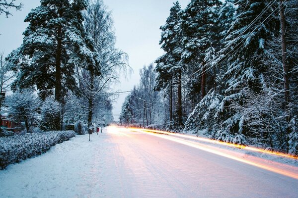 Winter road and lights from passing cars