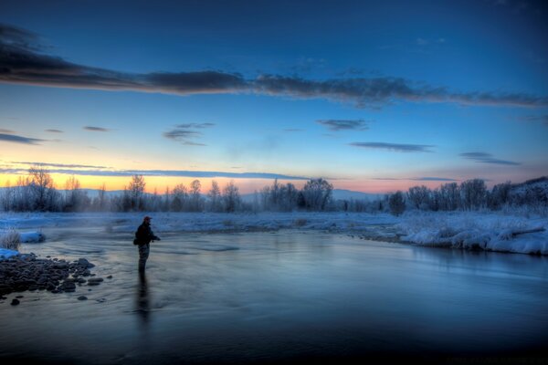 The man on the ice. Winter evening