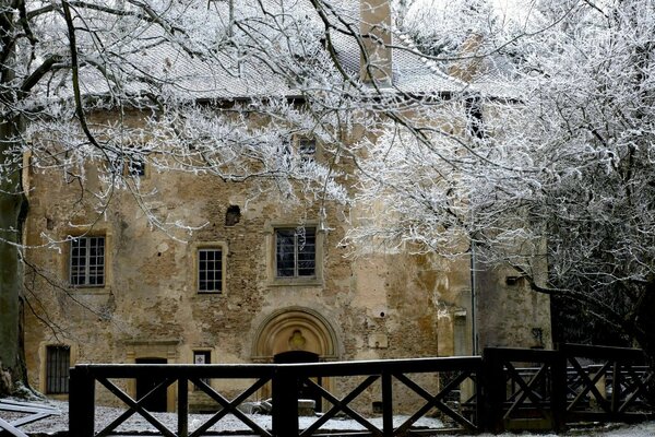 Ancient snow-covered stone house