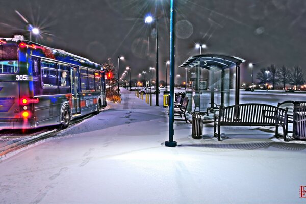 Urban winter landscape. The bus is standing near the bus stop