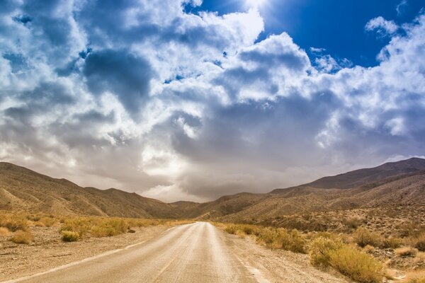 A road in a deserted area among bald hills