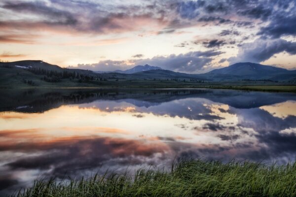 Lake on the background of a heavenly sunset landscape