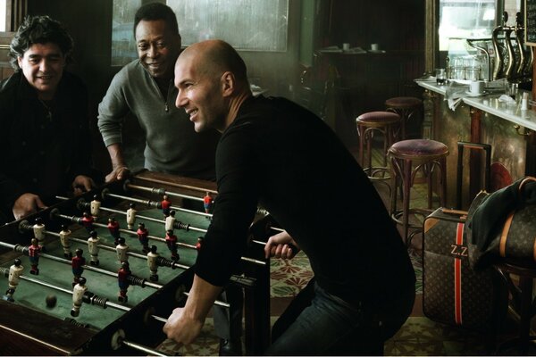 Men in a pub playing table football