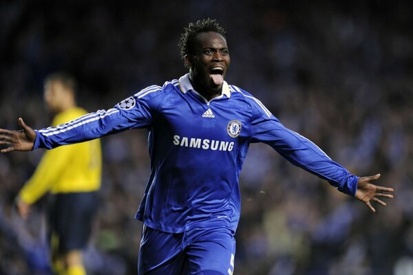 A FOOTBALL PLAYER CELEBRATES SCORING A GOAL