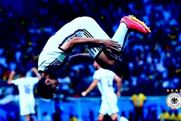 A football player doing a somersault during a football match