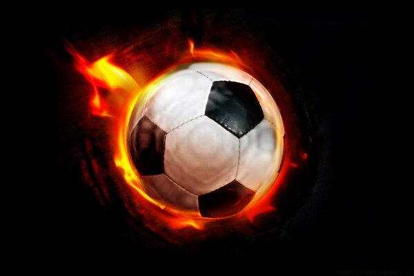 Soccer ball on a black background, shrouded in flames