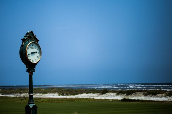 Photo of a street clock on the background of the sea