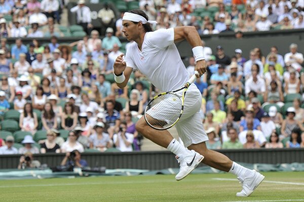 Tennis match. A pumped-up tennis player runs across the field