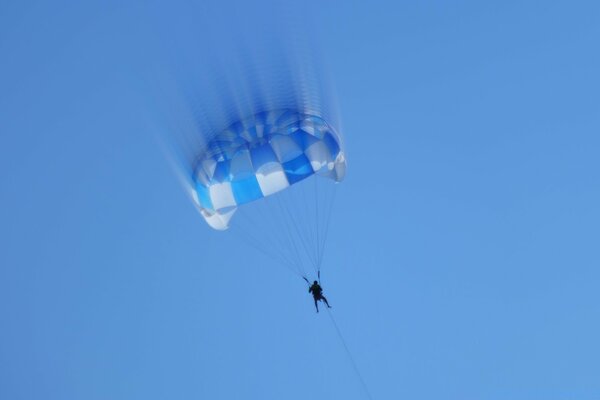 A human-controlled checkered parachute